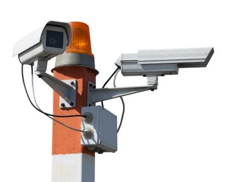 Two CCTV security cameras on red striped pillar with orange flashing light. I Stock Photos