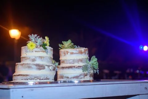 Two celebratory cake on a table. Night scene. Stock Photos