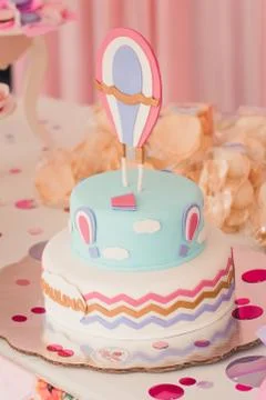 Two celebratory cake on a table at night. Stock Photos