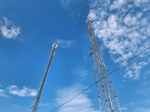 Two cell towers on blue background Stock Photos