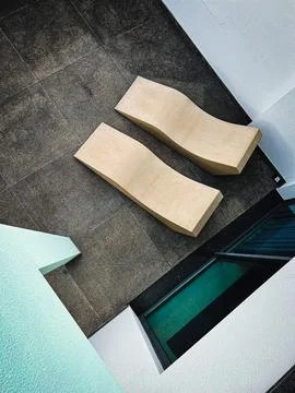 Two cement benches gracefully positioned on a concrete patio, highlighting urban Stock Photos
