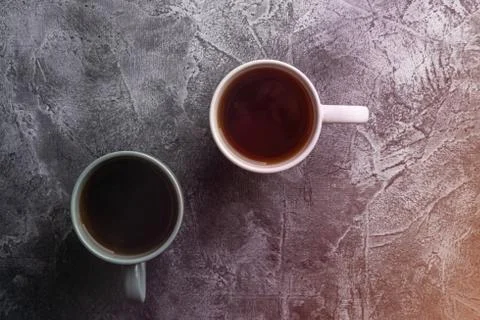 Two ceramic cups with black tea, hot drink in white and grey cup Stock Photos
