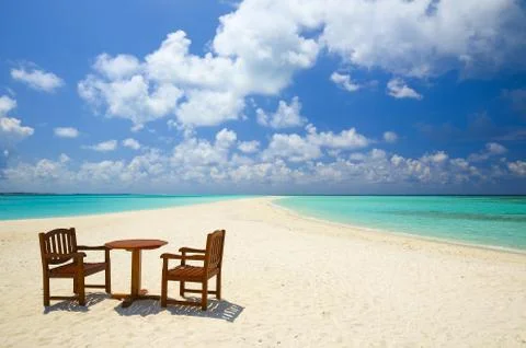 Two chairs and one table are on the coral sandy beach, Maldives 写真素材