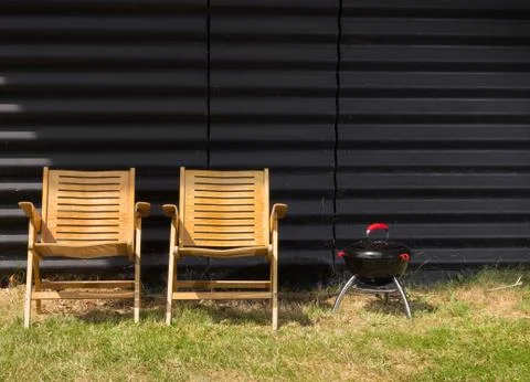 Two chairs and a small barbeque Stock Photos