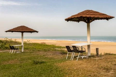 Two chairs and a table are placed facing the sea Stock Photos