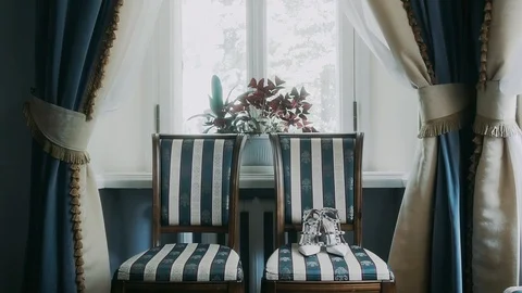 Two chairs stand near the window Stock Footage 119306798