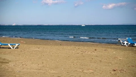Two chaise-longue at perfect wild sandy beach with blue sea view, nobody, travel Stock Footage 79043274