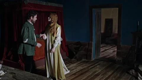 Two characters interact in an indoor setting during a dramatic moment Stock Footage 327967173