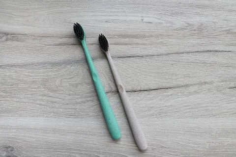 Two charcoal toothbrushes Stock Photos