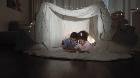 Two charming children a boy and a girl paint coloring books Stock Footage 115575963