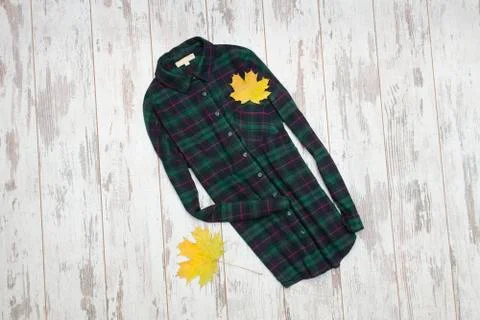 Two checkered shirts and maple leaves. Fashionable concept Stock Photos