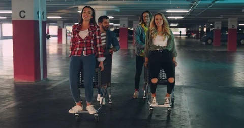 Two cheerful caucasian couples of young hooligans having fun at the parking Stock Footage 101028743
