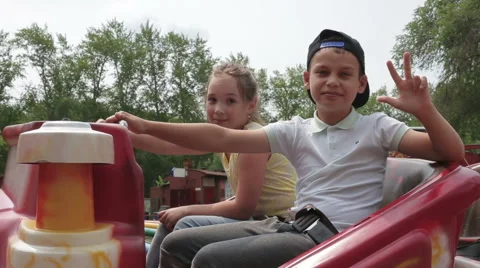 Two cheerful child prepare for a trip to the attraction, waving their hands and Stock Footage 64959372