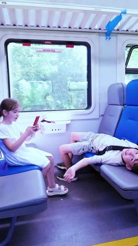 Two cheerful children having fun, playing and using a smartphone inside a Stock Footage 338397157