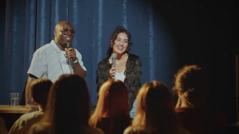 Two Cheerful Comics Performing Comedy on Stage in Stand-Up Club Video stock 278599253