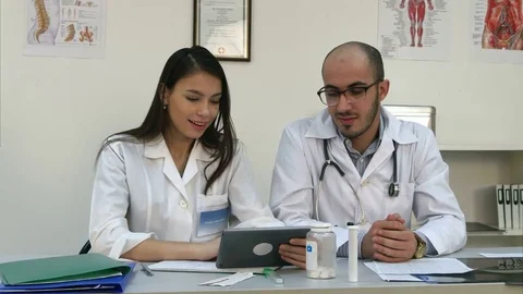 Two cheerful doctors having positive video call via tablet Stock Footage 72400931