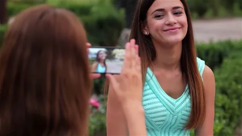 Two cheerful girlfriends capturing a selfie moment Stock Footage 311661794