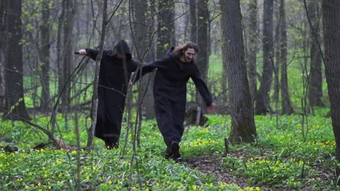 Two cheerful monks are running through the forest Stock Footage 198178477