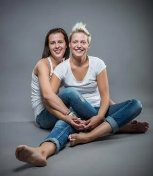 Two cheerful sisters having fun in the studio. Stock Photos