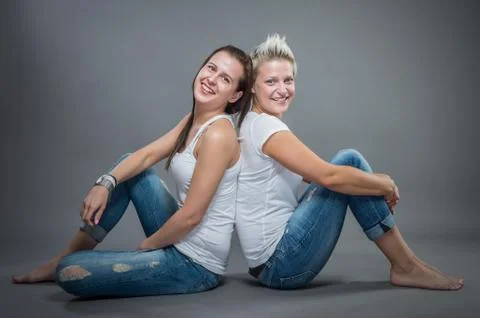 Two cheerful sisters having fun in the studio. Stock Photos