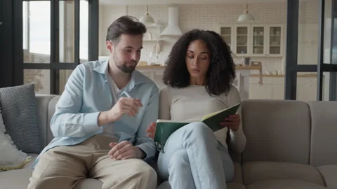 Two Cheerful Students Study in Living Room and Write Notes from Lessons Stock Footage 298183356