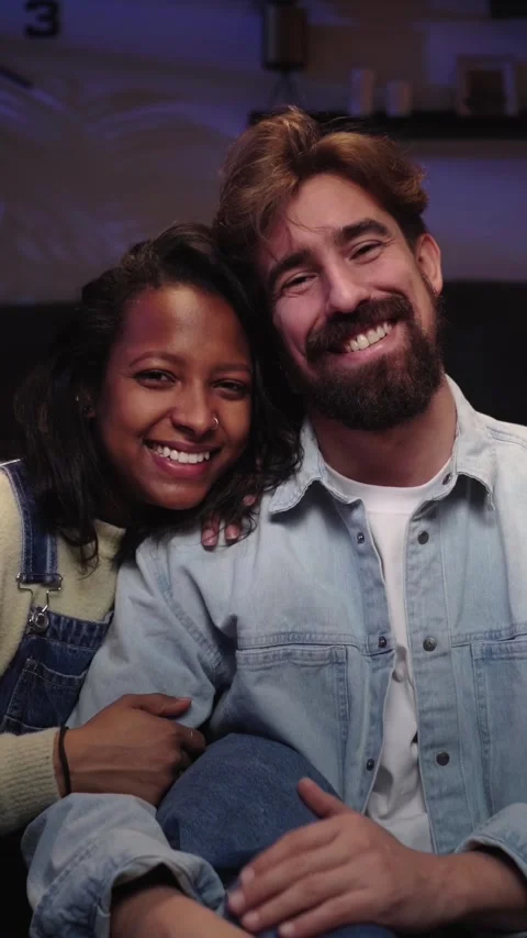 Two cheerful young in love looking at smiling camera in living room Stock Footage 275180225