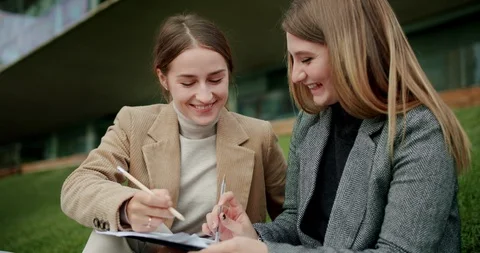 Two cheerful young students female studying university material with positive Video stock 120745895