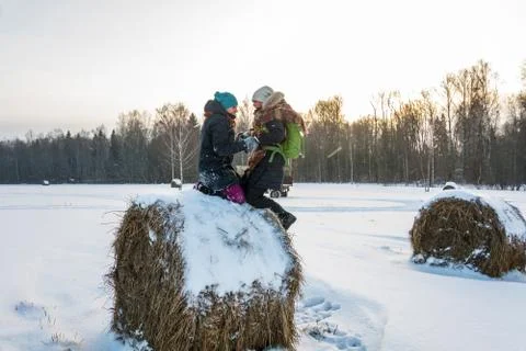 Two cheerful young women on a haystack. Stock Photos