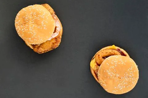 Two cheeseburgers on a dark background Stock Photos