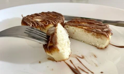 Two cheesecakes for breakfast on a white plate Stock Photos