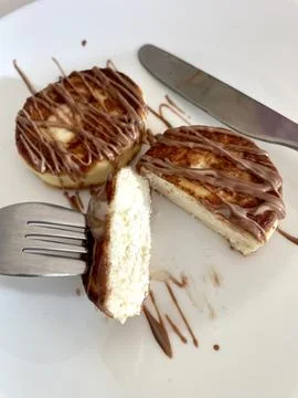 Two cheesecakes for breakfast on a white plate Stock Photos