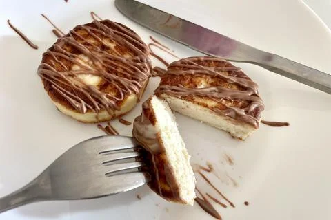 Two cheesecakes for breakfast on a white plate Stock Photos