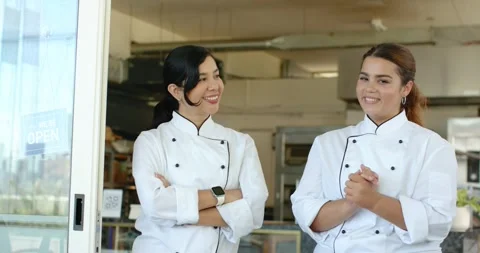 Two chefs are exchanging looks, smiling and posing at shop door with QR code, Stock Footage 344331456