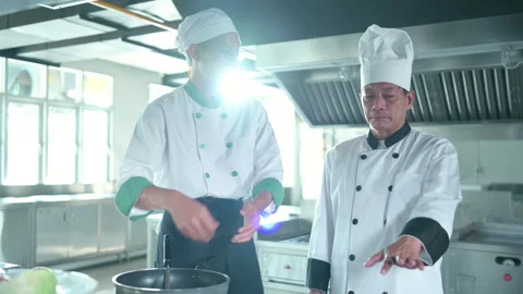 Two chefs consult with each other before working on the main dish. Stock Footage 255999963