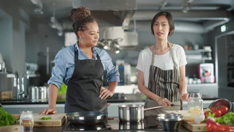 Two Chefs Cooking Talking Stock-Footage 169478095
