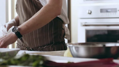Two chefs cooking together at their work stations in interior kitchen with soft Stock Footage 199463328