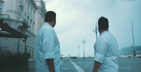 Two chefs have a conversation on city square Stock Footage 204973295