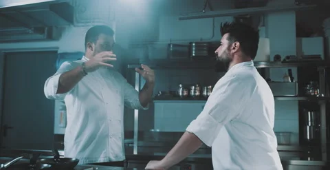 Two chefs have a conversation in kitchen Video stock 204972623