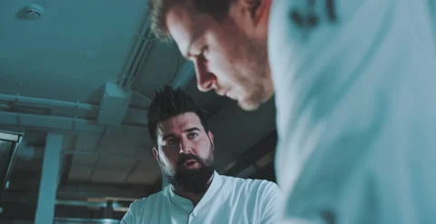 Two chefs have a conversation in kitchen Stock Footage 204973550