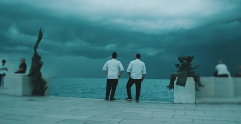 Two chefs have a conversation by the water Stock Footage 204973447
