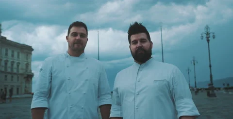 Two chefs look toward camera Stock Footage 204973372