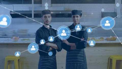 Two chefs posing in kitchen, blue node appearing then spreading, overlaying 動画素材 332577504
