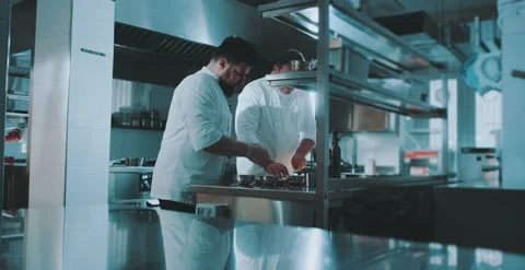 Two chefs prepare spices in industrial kitchen Stock Footage 204973166