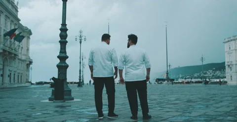 Two chefs stand and talk while pointing Stock Footage 204973438