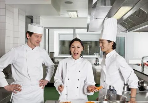 Two chefs teasing another chef Stock Photos