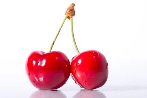Two cherries close-up on white background Stock Photos