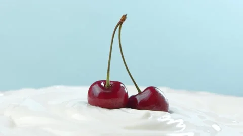 Two cherries on a twig in white ice cream Stock Footage 138369642