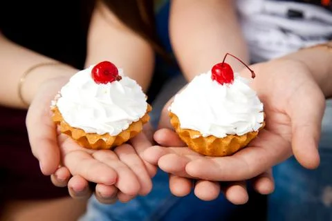 Two cherry cakes on top. Cake hand cupcakes with cream. Stock Photos