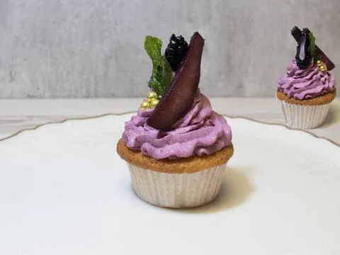 Two cherry cup cakes with pickled pear Stock Photos