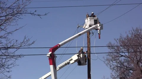 Two Cherry Pickers at power pole -Utility Workers at two levels Stock Footage 105138667